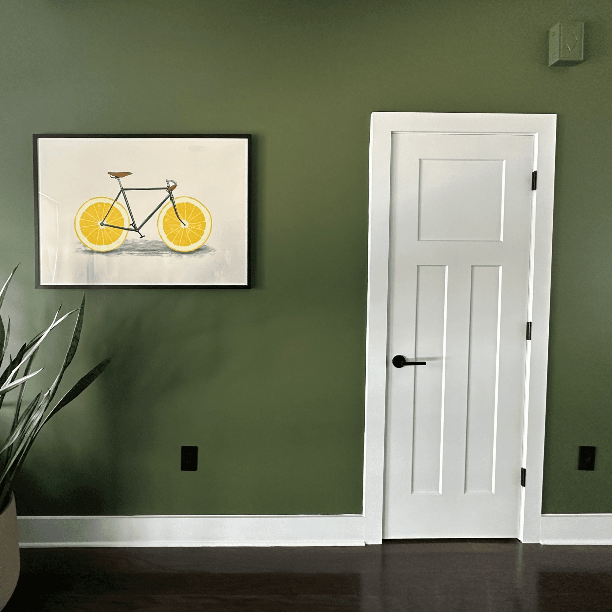 Craftwork painted a kitchen accent wall in Sherwin-William’s Oakmoss (SW6180).