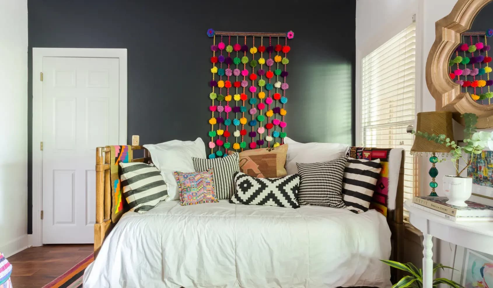 Black Ink by Benjamin Moore on the accent wall, white walls in Sherwin-Williams Snowbound, featured in Apartment Therapy, photo by Julia Steele