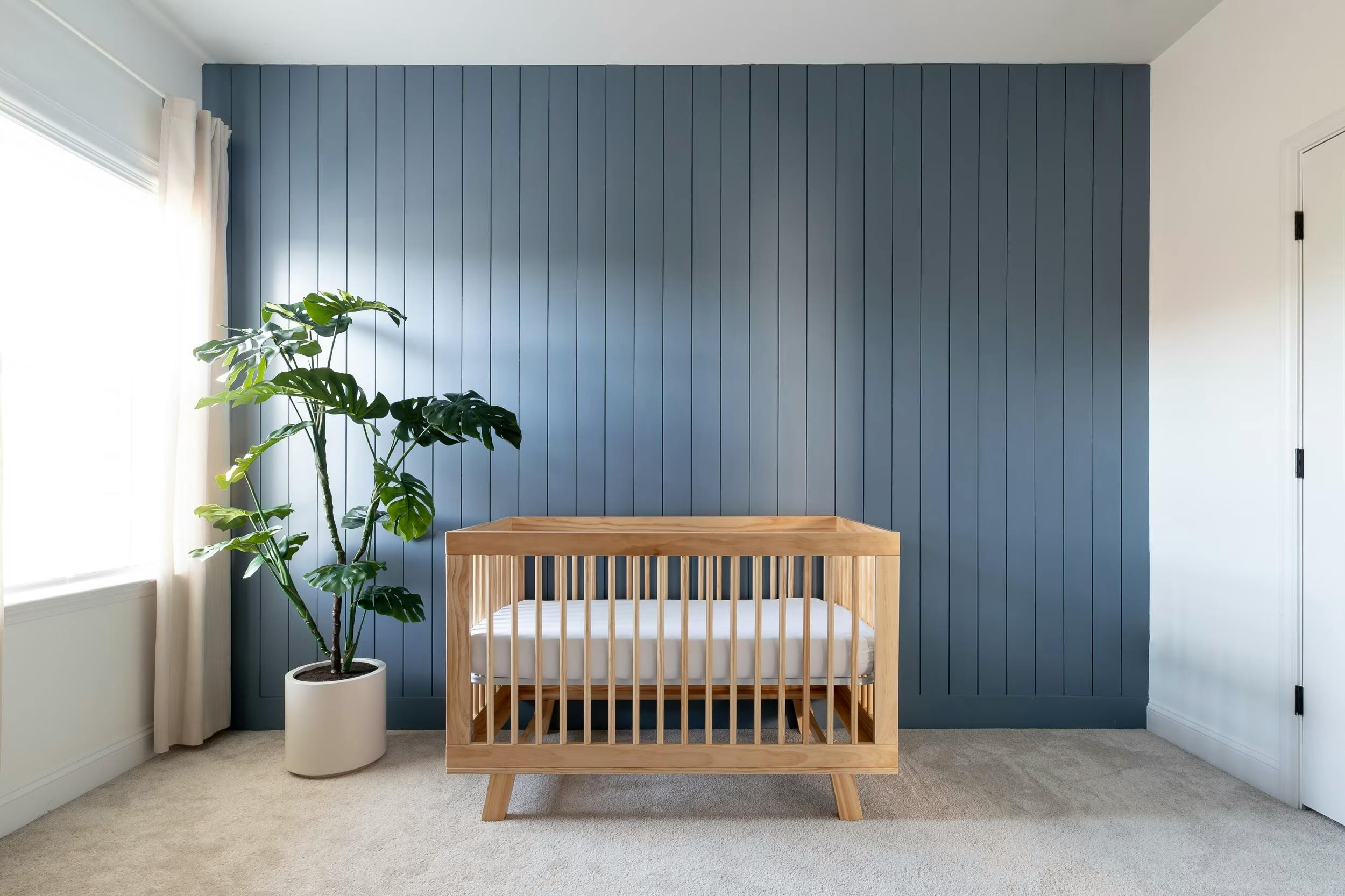 This Charlotte nursery was painted by Craftwork in Bachelor Blue 1629 by Benjamin Moore.